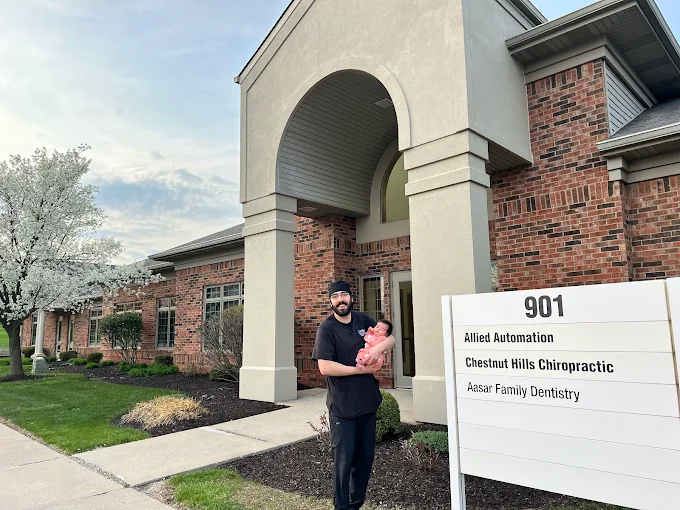 Aasar Family Dentistry office exterior with sign and family